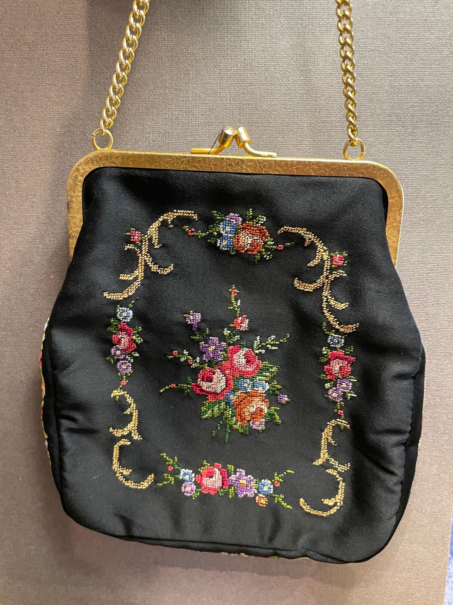 Small vintage embroidered fabric bag on a chain